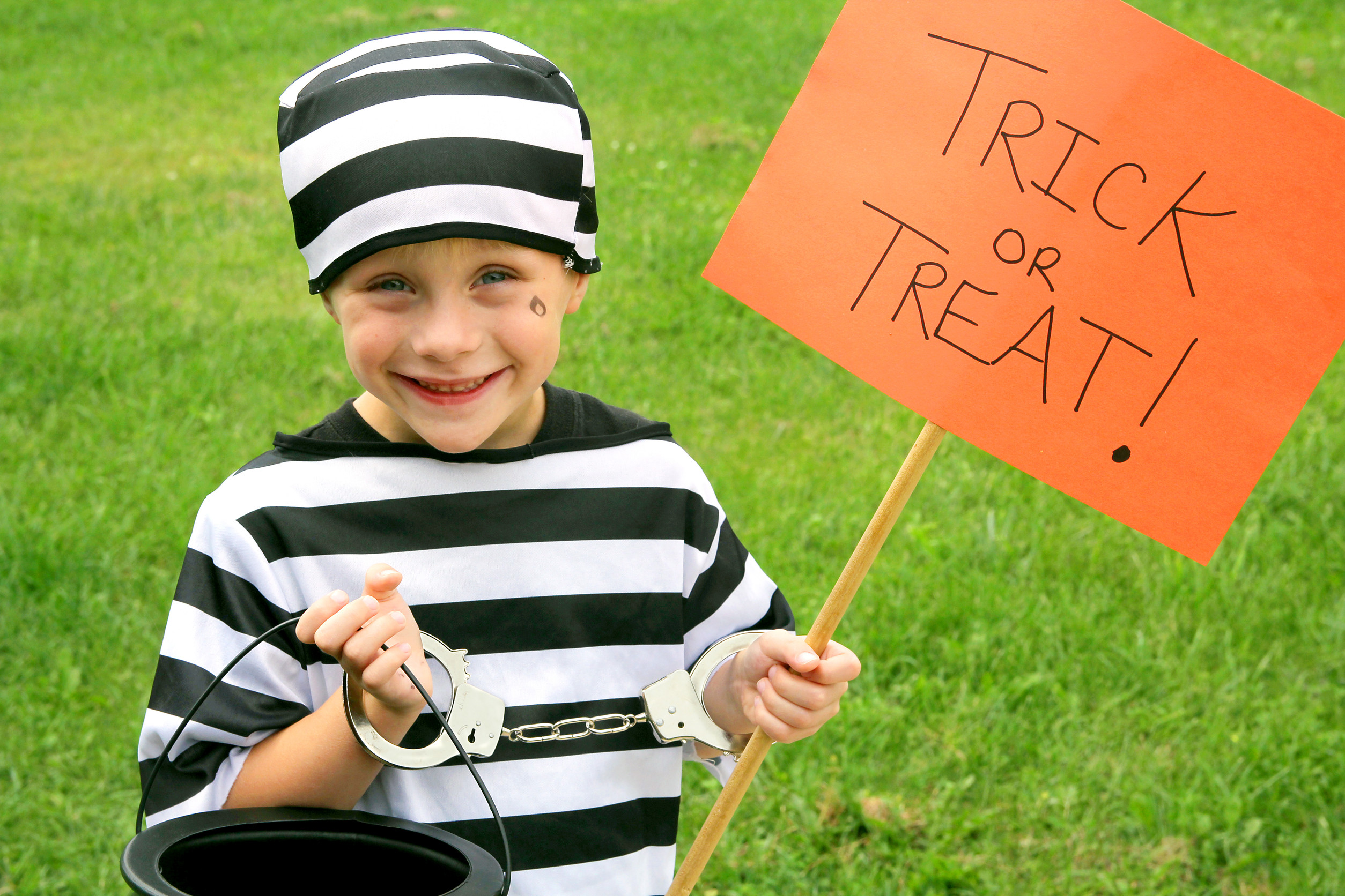 A young American child is dressed up in a prisoner costume on Halloween