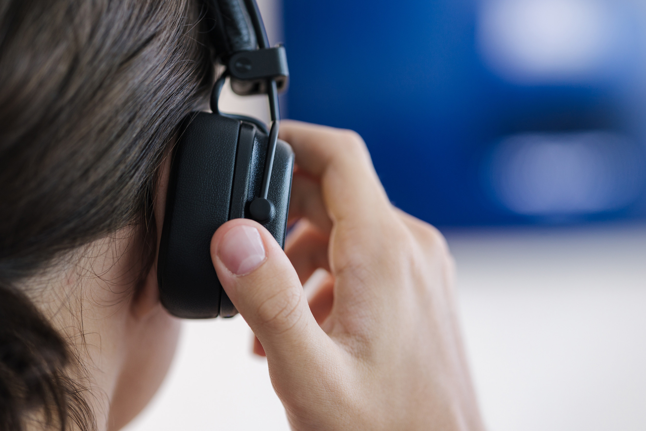teenage boy puts on wireless headphones