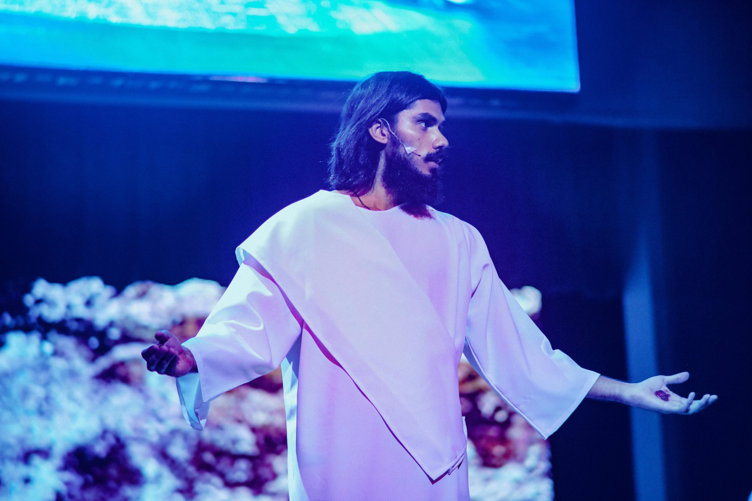 An Actor Portraying Jesus Standing on Stage