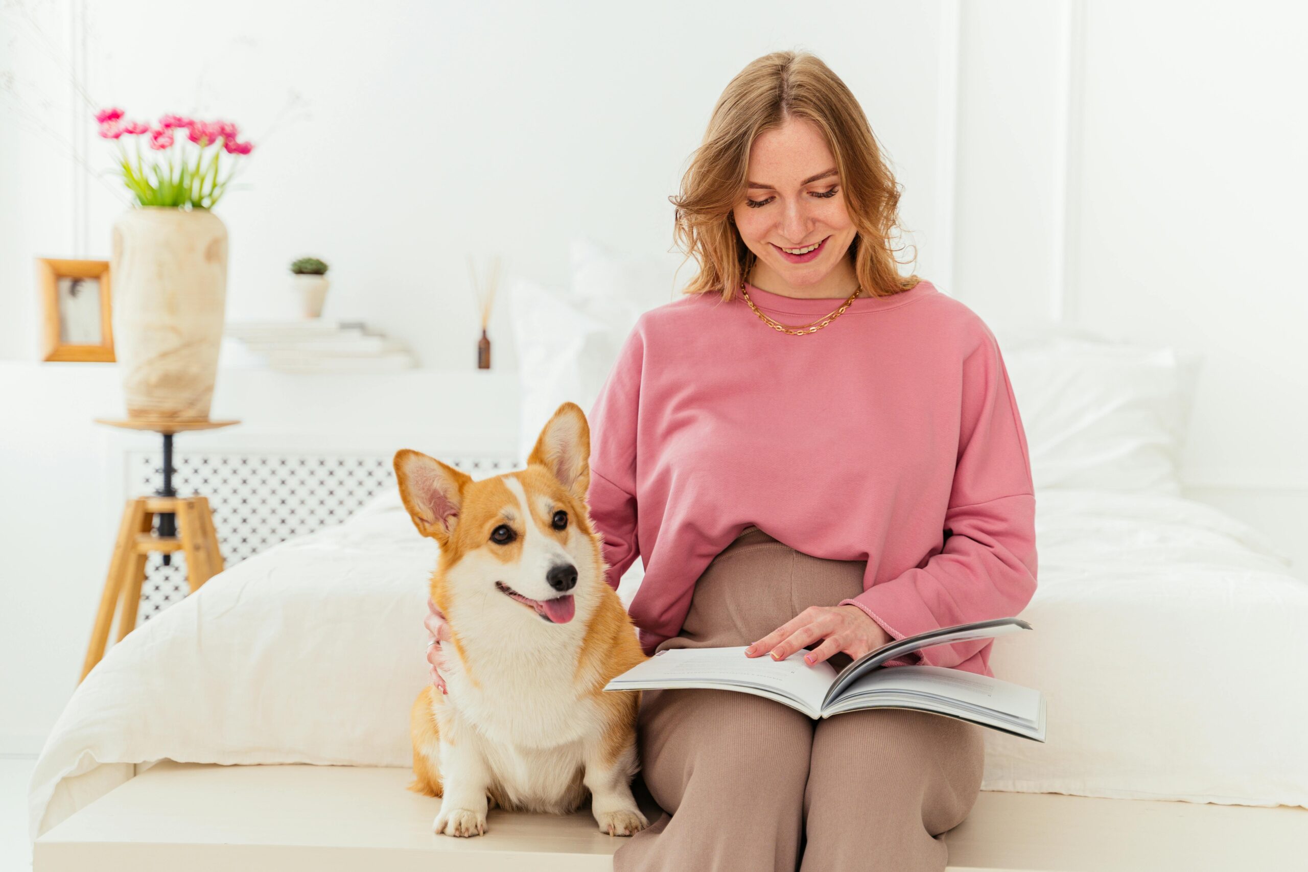 A Woman Sitting on the Bed with Her Dog