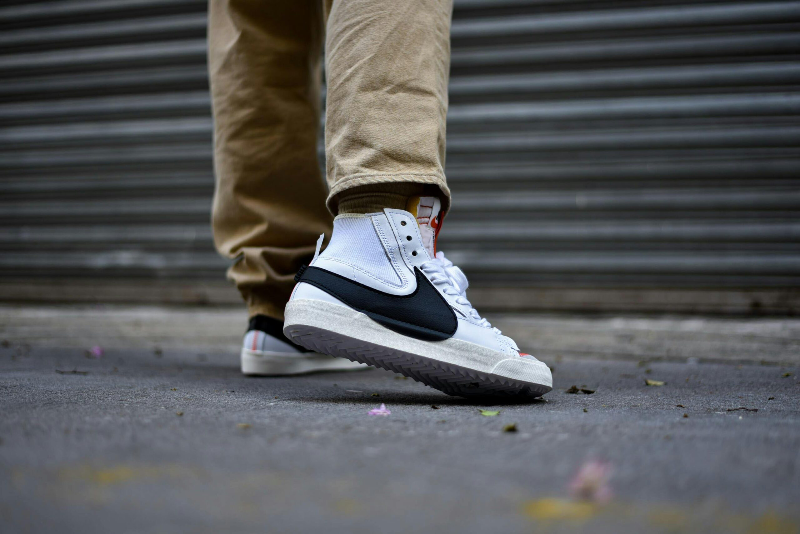 Person in Brown Pants Wearing Black and White Nike Sneakers