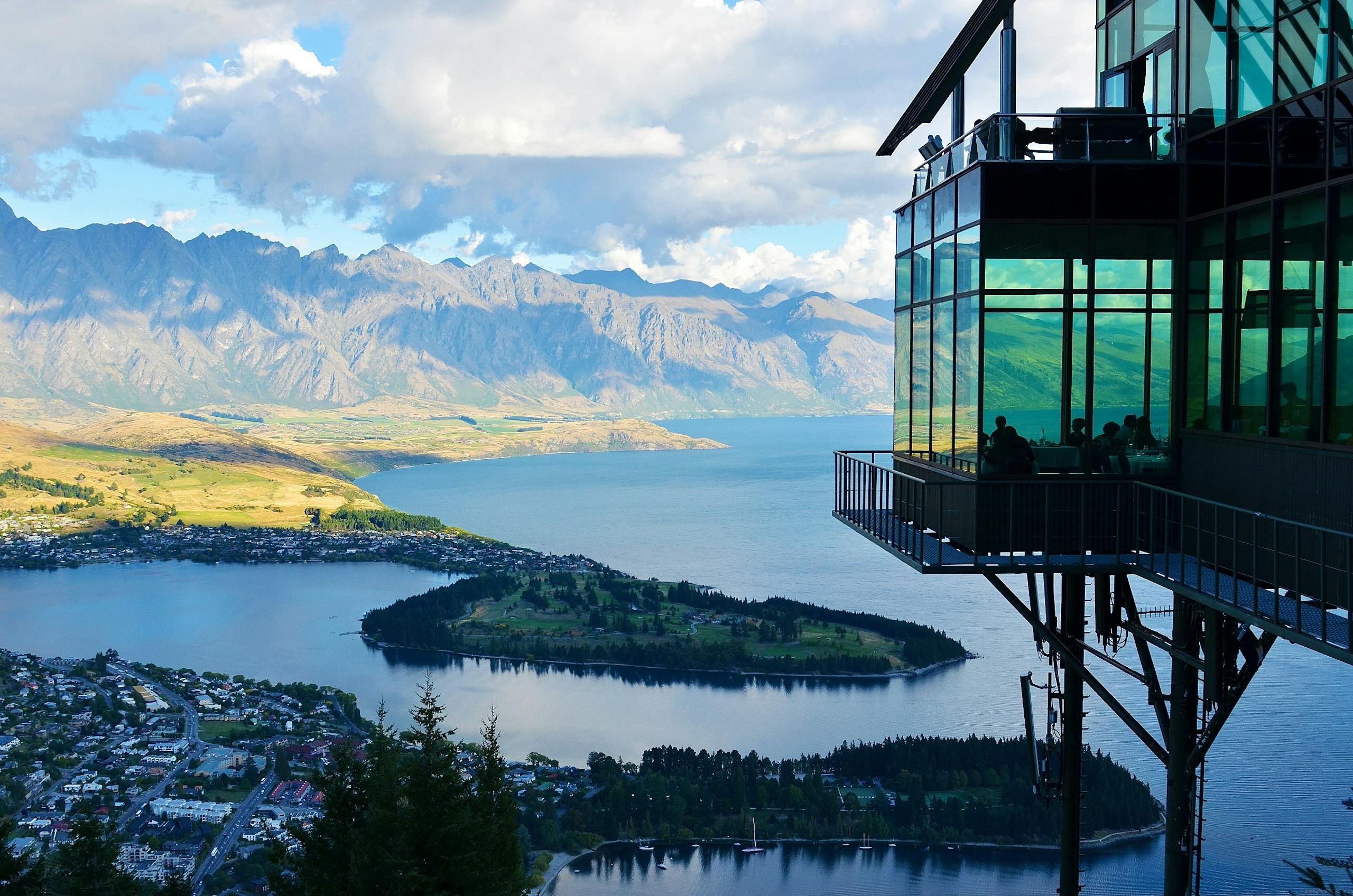 Experience a captivating view of Lake Wakatipu and The Remarkables from the Skyline Restaurant in Queenstown, New Zealand.