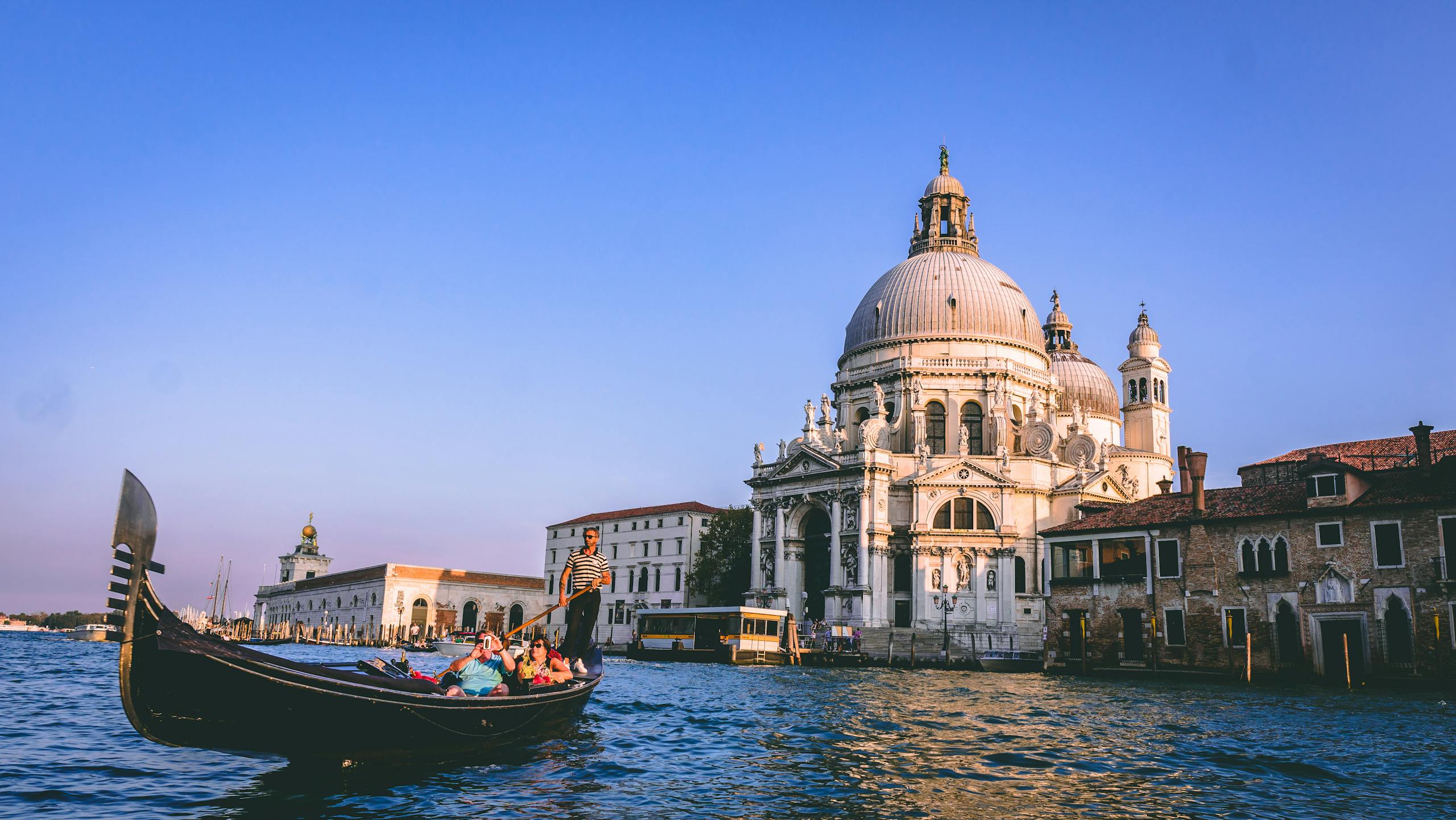 Scenic view of a gondola ride with Santa Maria della Salute in the background, Venice.