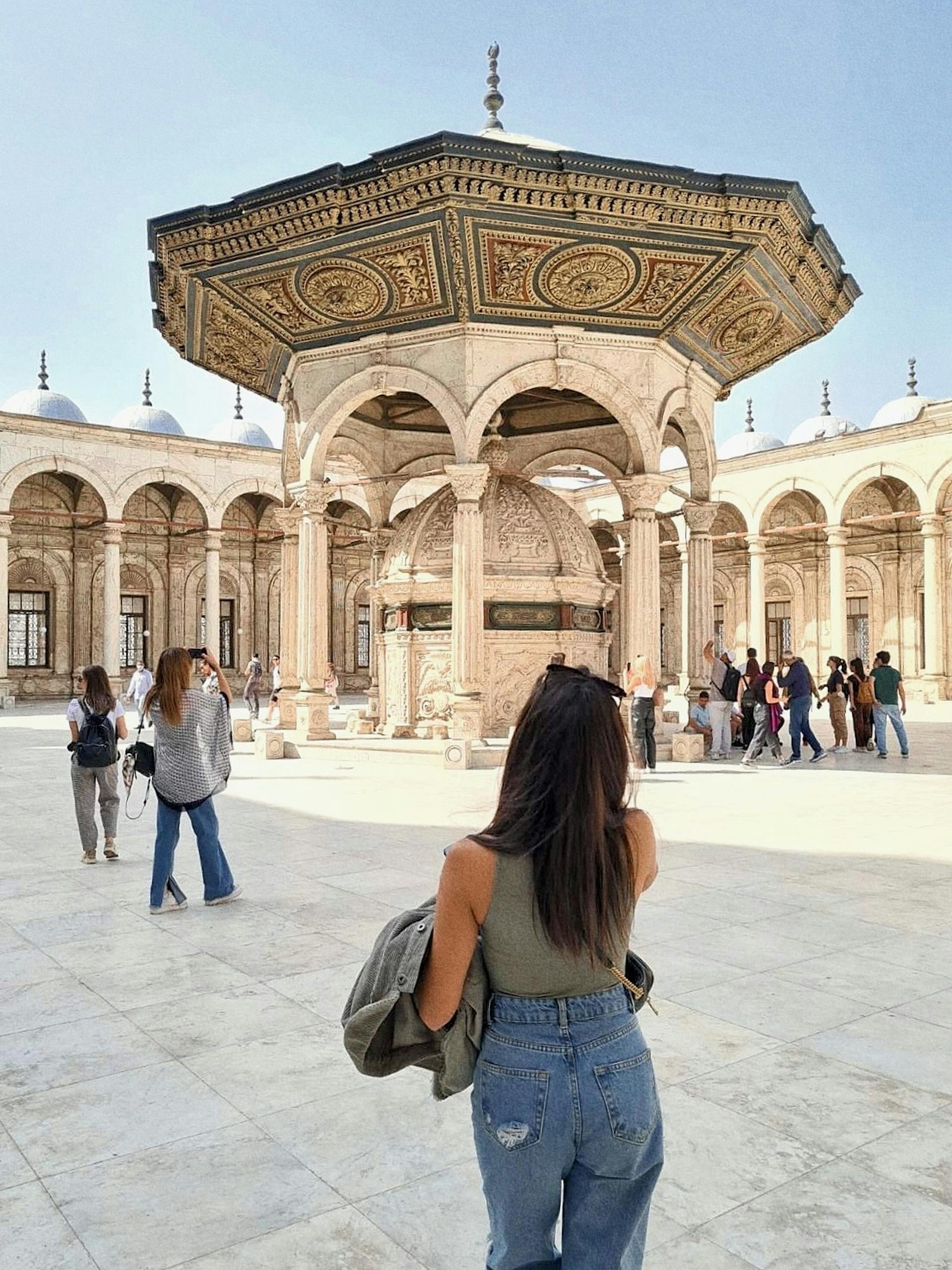 Woman exploring the courtyard of the Mosque of Muhammad Ali in Cairo, Egypt.