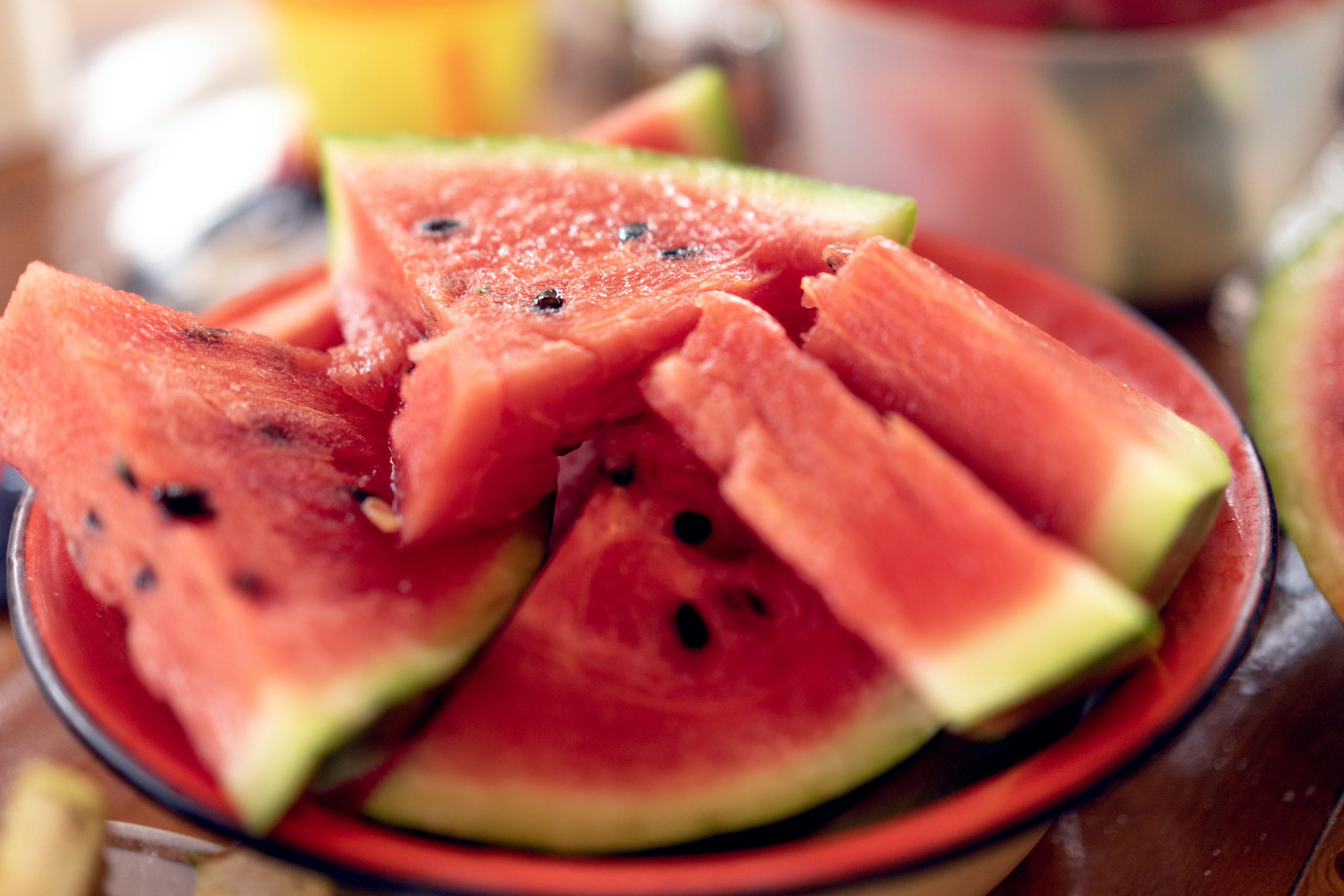 Close-up of fresh, sliced watermelons on a plate perfect for summer refreshment.