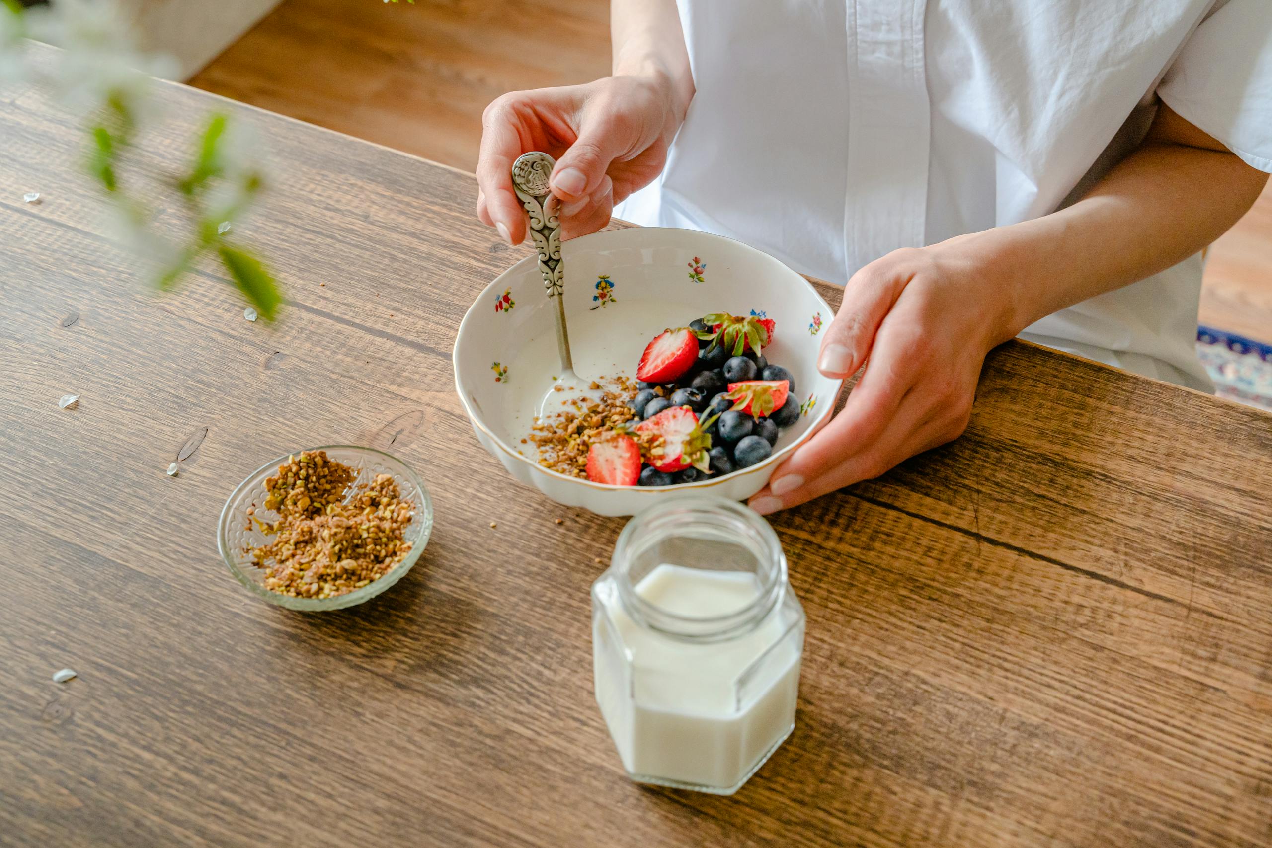 A vibrant homemade yogurt bowl with strawberries, blueberries, and crushed nuts, perfect for a healthy breakfast.