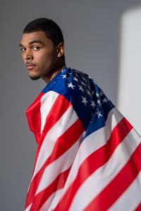 Male adult wearing American flag, symbolizing patriotism and national pride.