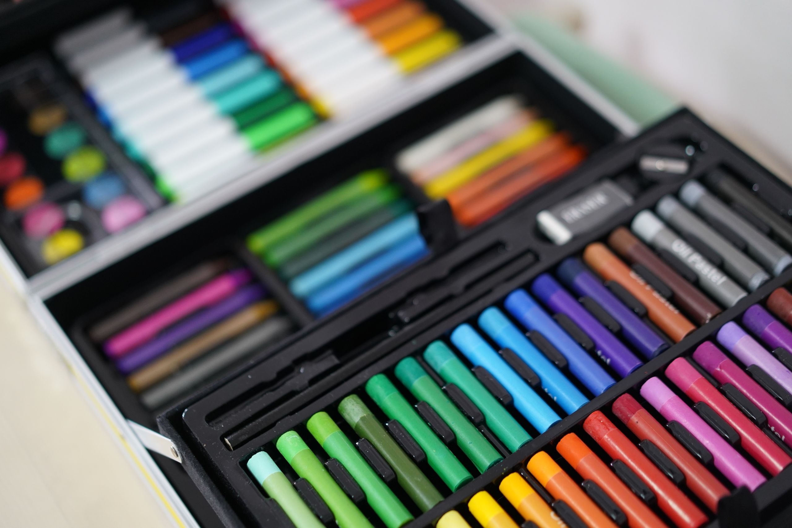 Close-up of a colorful art set with a variety of pencils and crayons.