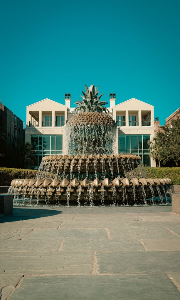 Elegant view of the renowned Pineapple Fountain in Charleston under a clear blue sky.