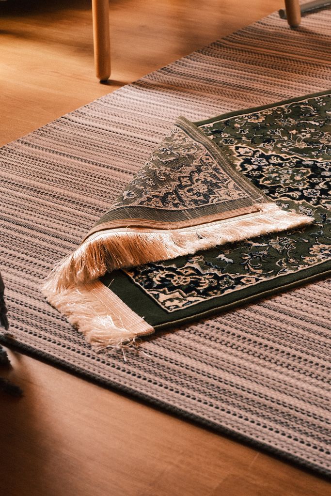Layered woven and oriental rugs in warm indoor ambiance, perfect for home decor inspiration.