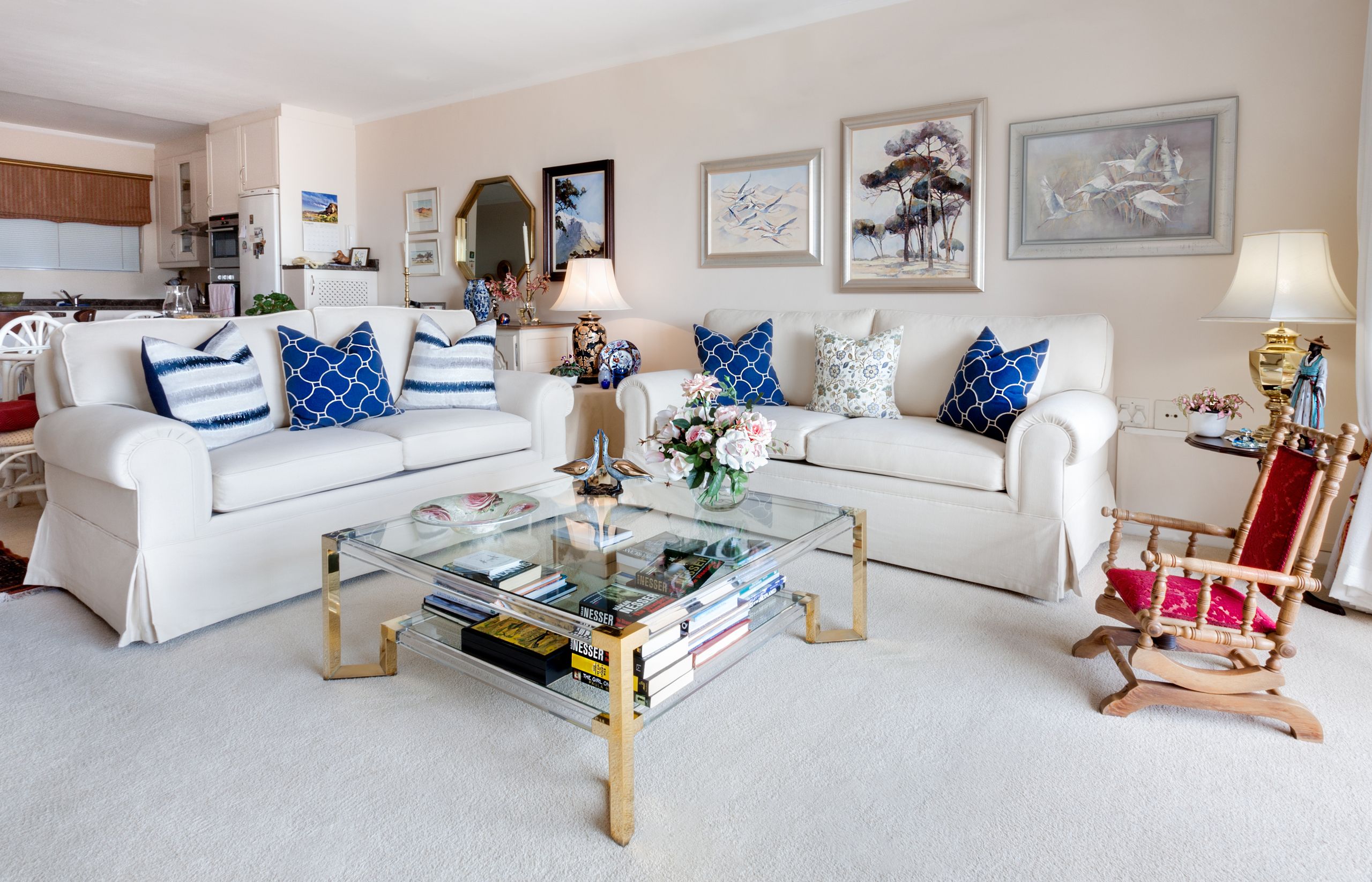 Modern living room with stylish decor and comfortable white sofas.