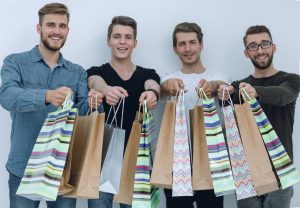 paper bags in the hands of a team of friends