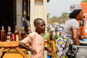 OUIDAH, BENIN - Jan 10, 2017: Unidentified Beninese little boy puts his hand into the pocket at the local market. Benin children suffer of poverty due to the bad economy
