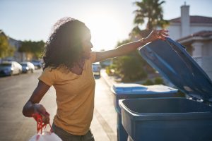african american woman taking out the trash in las vegas neighborhood,