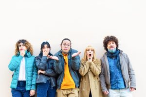 Happy friends from different cultures and races making funny faces after lockdown reopening.Youth, millennial generation and friendship concept with young people having fun together.new normal lifestyle