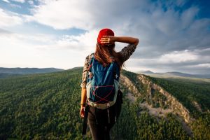 A woman is traveling in Bashkiria, Russia. Mountain tourism in Russia. Walking tour of the mountains of Bashkiria, Aigir. A trip to the mountains with a backpack. Copy space