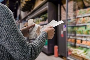 Man in protective mask buying food during quarantine