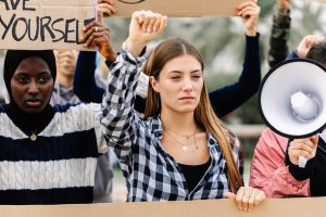 Crowd of diverse student protestors demonstrating against climate change