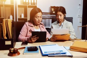 Consultation and conference of professional businesswoman and Male lawyers working and discussion having at law firm in office. Concepts of law, Judge gavel with scales of justice
