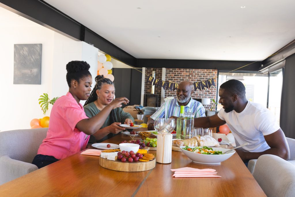 Family enjoying festive meal together at home, sharing food and laughter. celebration, dinner, gathering, holiday, bonding, happiness