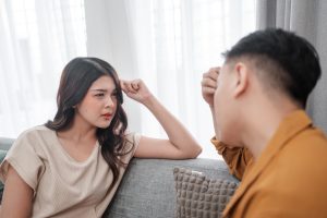 A couple shares a serious, heartfelt discussion at home, showcasing their genuine emotions