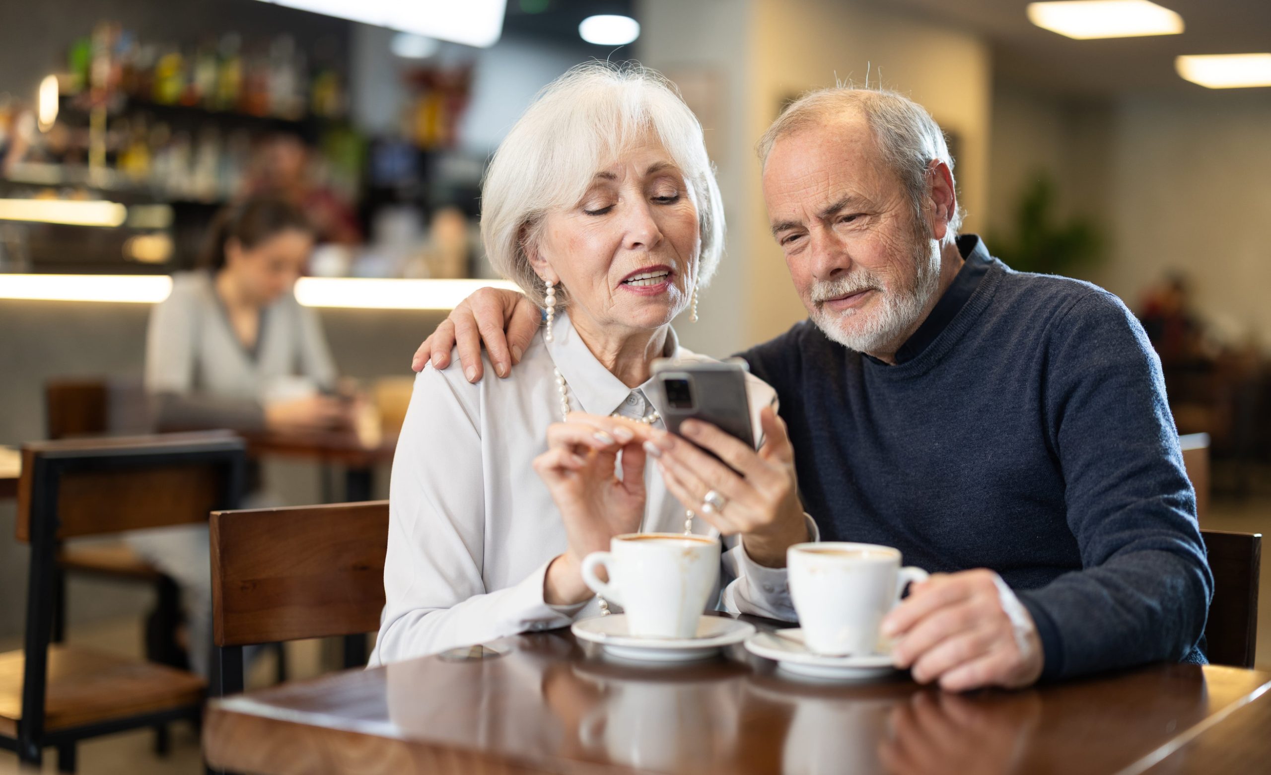 Couple of men and women talking and drinking coffee