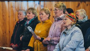 Trokeli, Belarus - April 17, 2022: Parishioners singing hymns during a mass in Trokiele Church