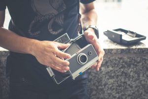 Close-Up Hands Of A Man With Old Classic Camera.