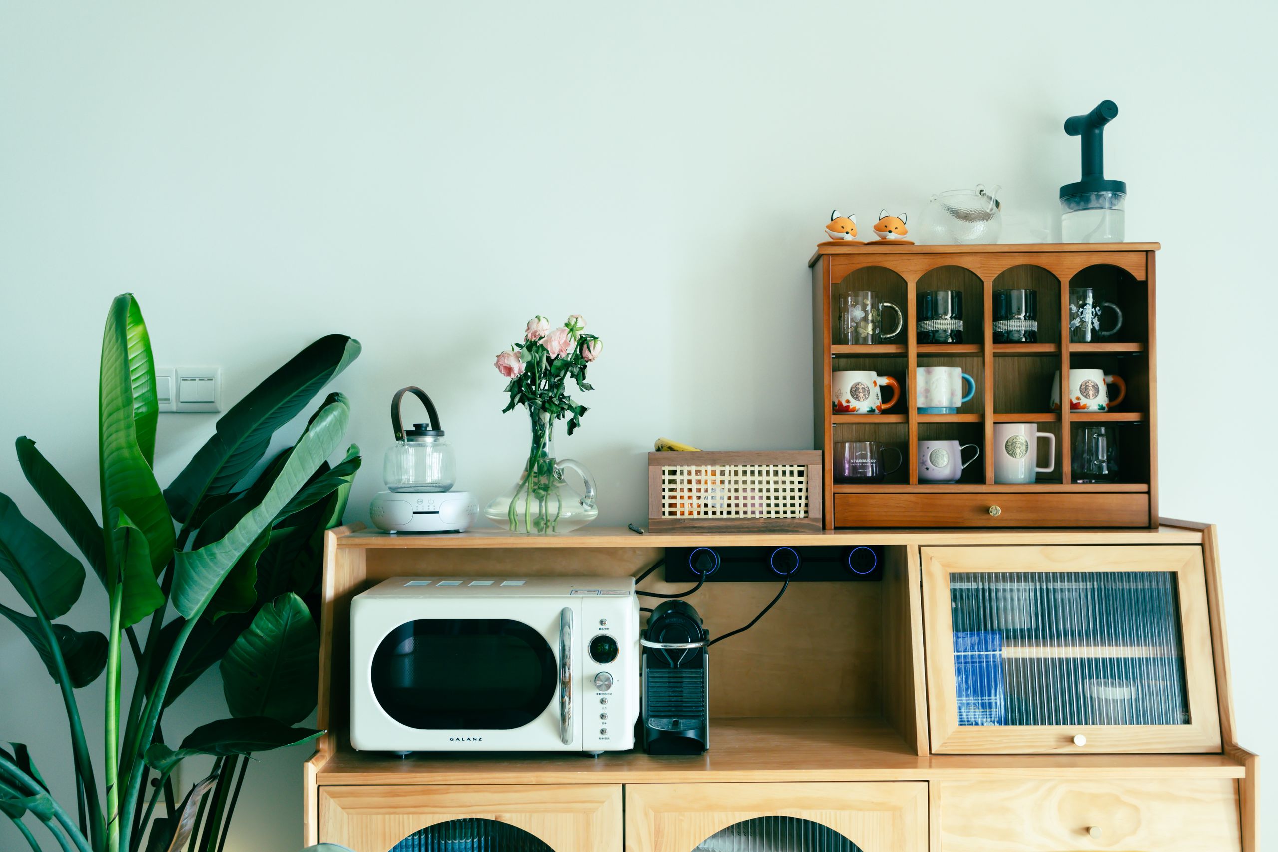 Charming kitchen setup featuring vintage appliances and decor on a wooden dresser.