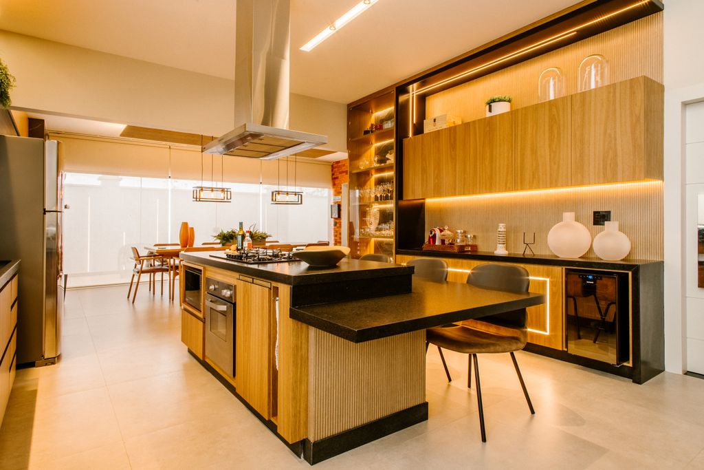 Elegant kitchen interior featuring wooden cabinets, island, and modern lighting.