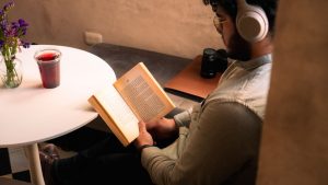 man-sitting-in-a-cafe-and-reading-a-book