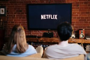 /man-and-woman-sitting-on-a-couch-in-front-of-a-television