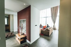 /two-person-sitting-on-sofa-beside-glass-