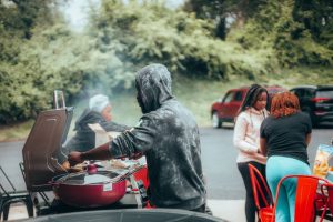 man-cooking-sausages-on-the-grill-at-a-picnic-