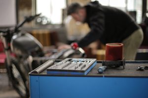 toolbox-with-small-metal-parts-placed-on-metal-workbench-in-garage-