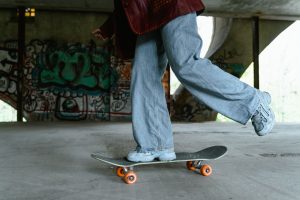 a-person-in-denim-jeans-on-a-skateboard-
