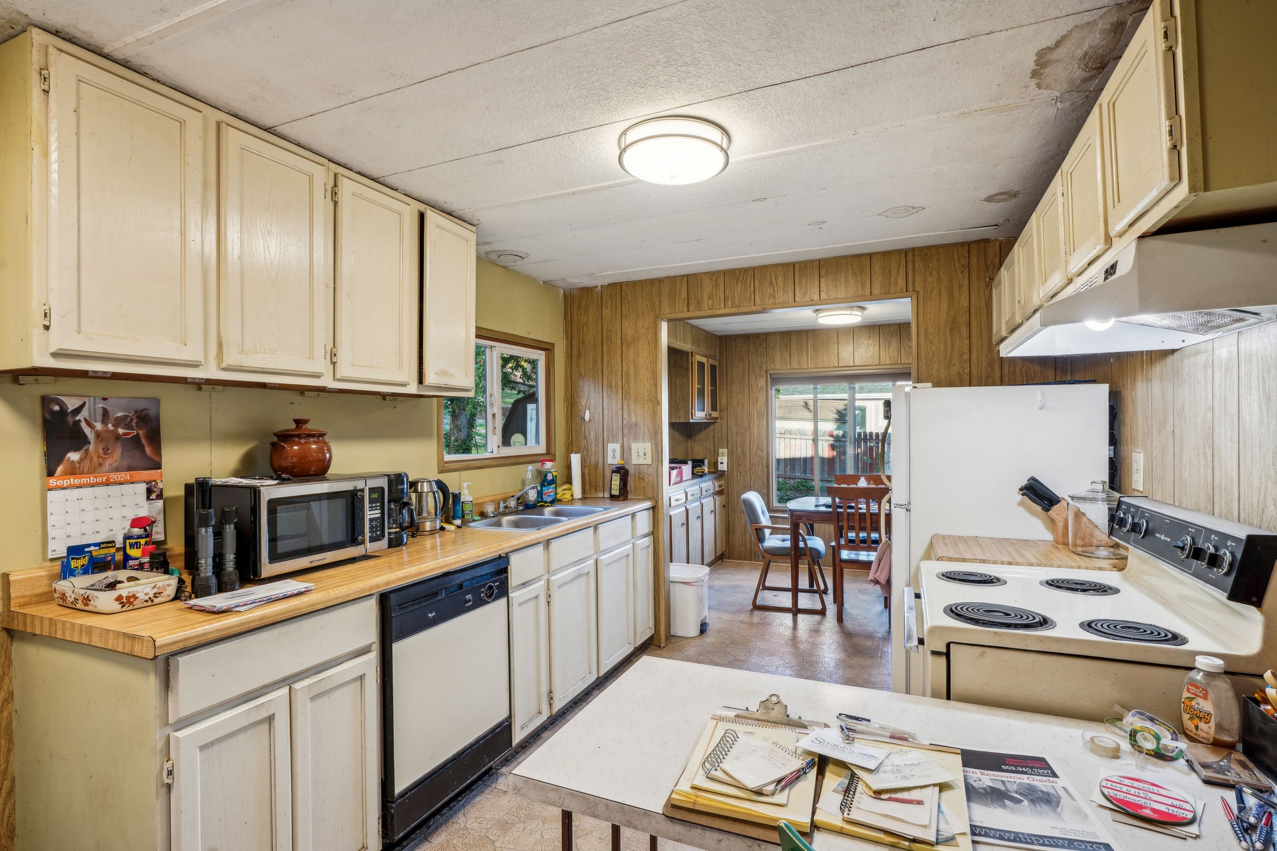Warm and functional kitchen interior with vintage oak cabinets and ample natural light.