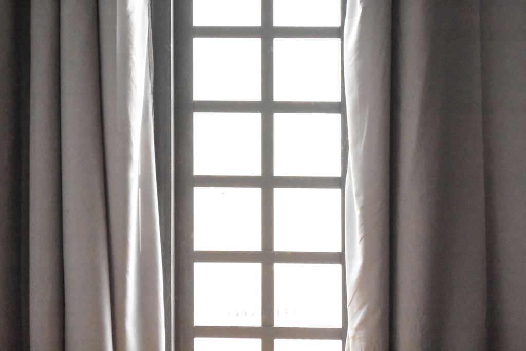 An elegant window with sheer curtains, capturing natural light and calm ambiance.