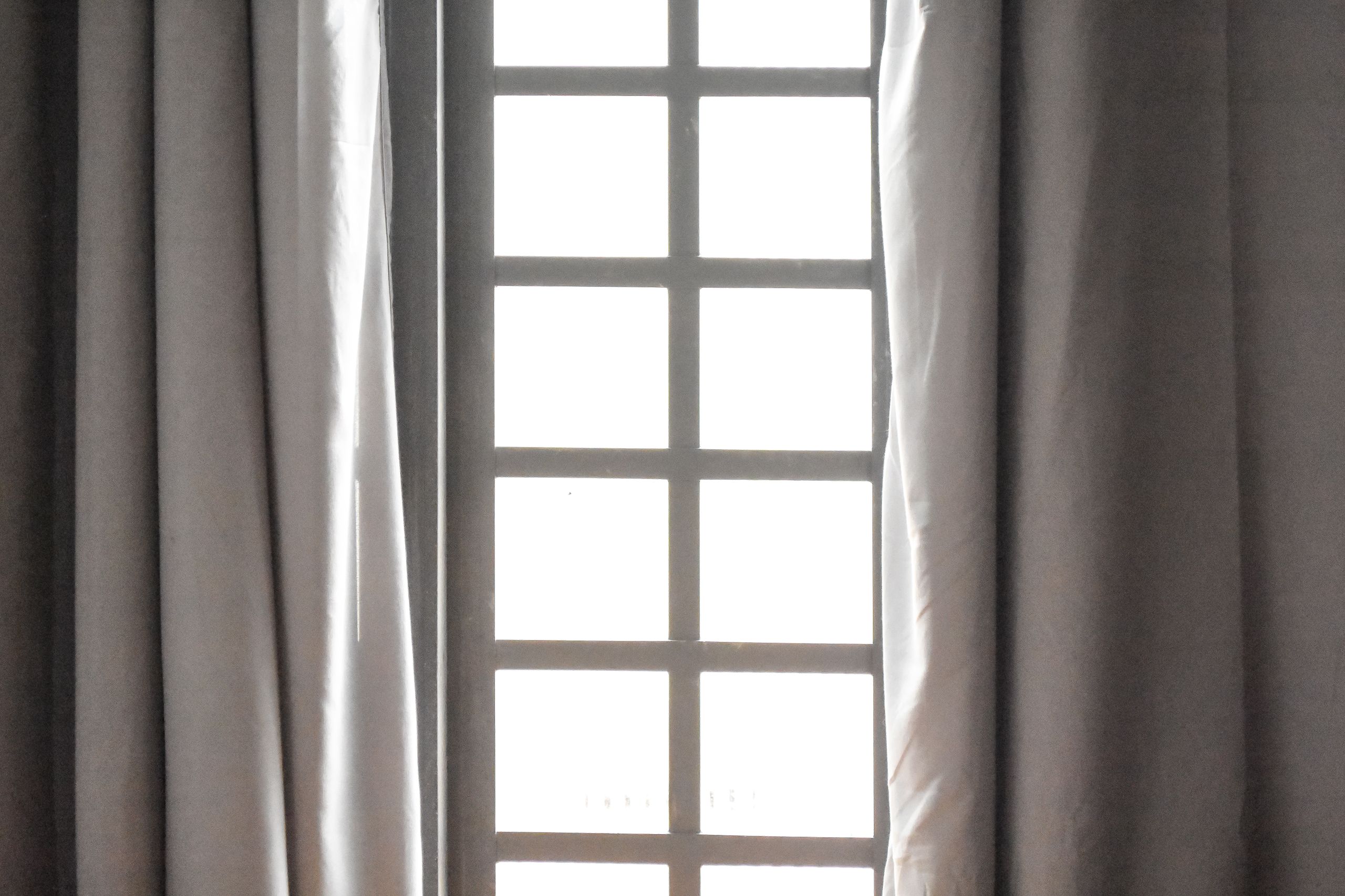 An elegant window with sheer curtains, capturing natural light and calm ambiance.