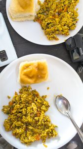 Top view of scrambled eggs with buns on a plate, perfect breakfast or brunch setting.